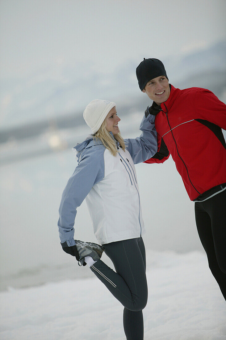 Young couple stretching before going running