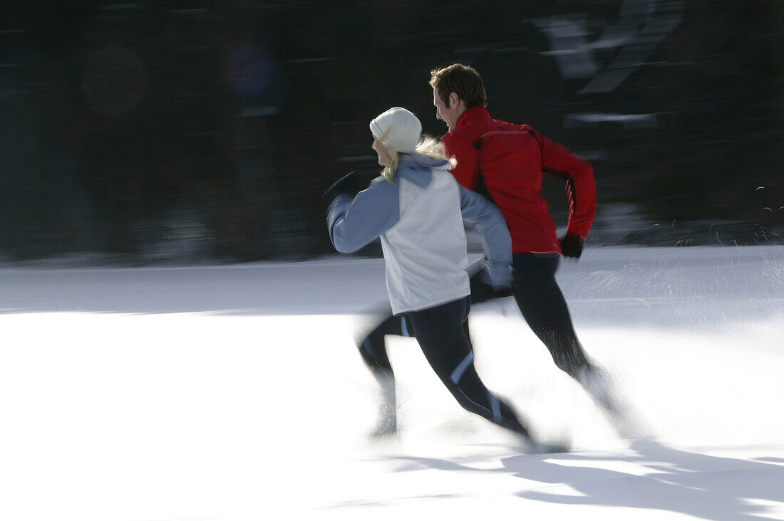 Young couple jogging on snow