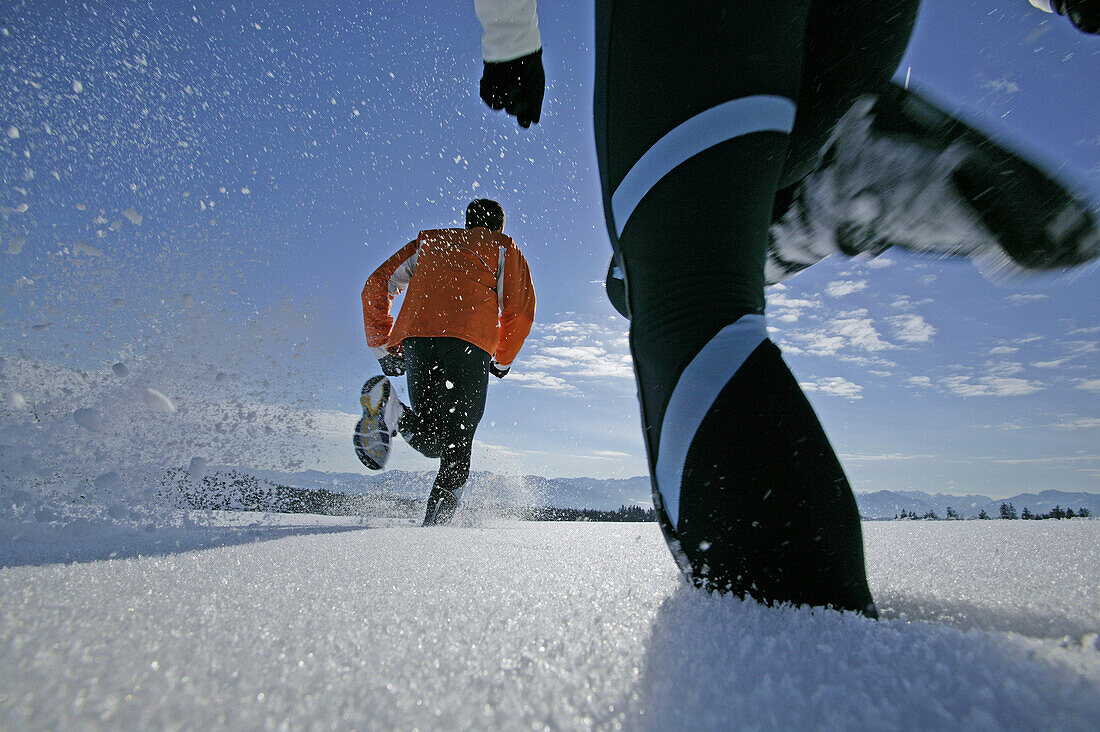 Young couple walking through powder snow