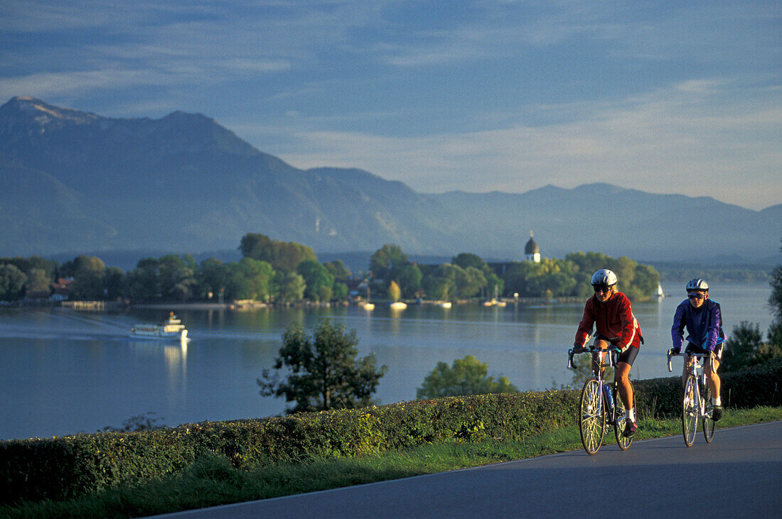 Two cyclists, Chiemsee, Fraueninsel, Chiemgau, Bavaria, Germany