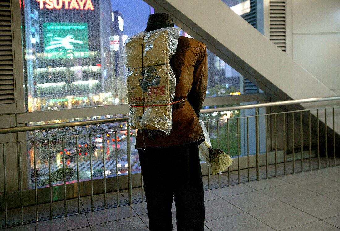 Homeless carrying his cardboard sleeping box on his back, Shibuya Station, Tokyo
