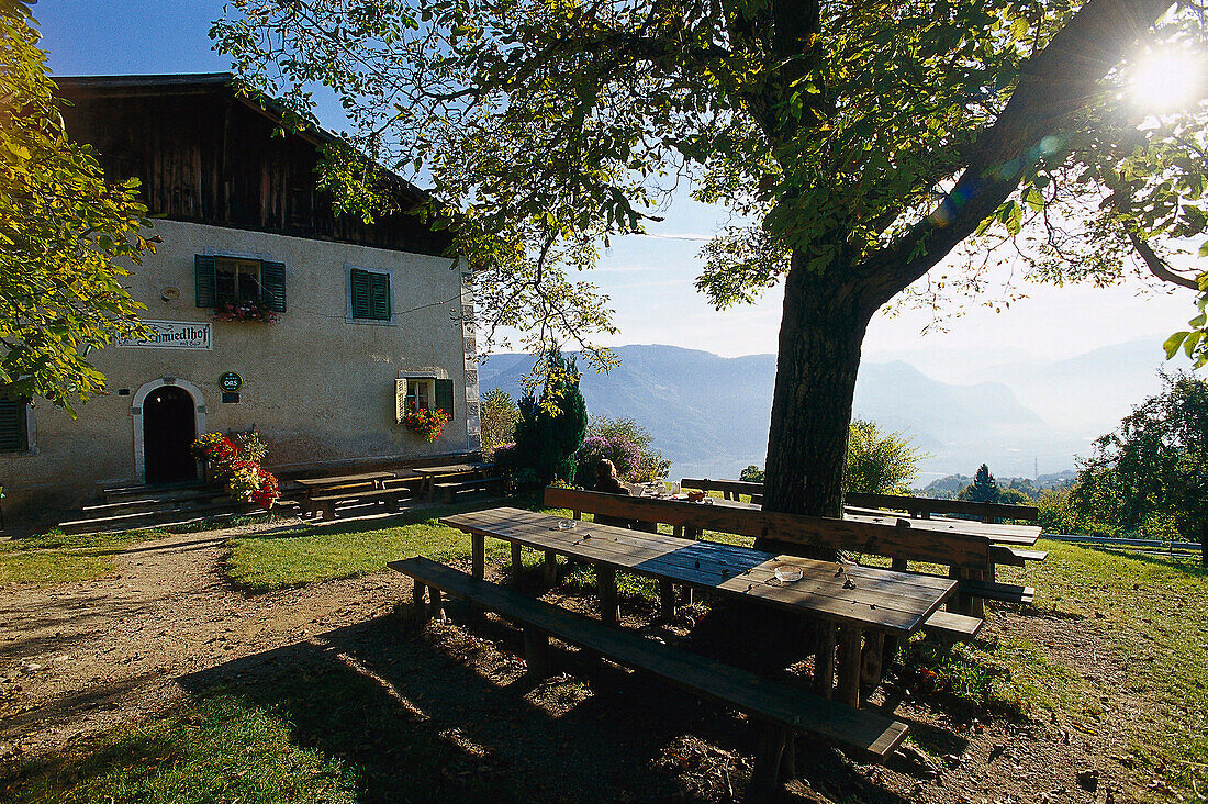 Relaxing after dinner under the mountain sun, Tavern Schmiedlhof near Grissian South Tyrol, Italy