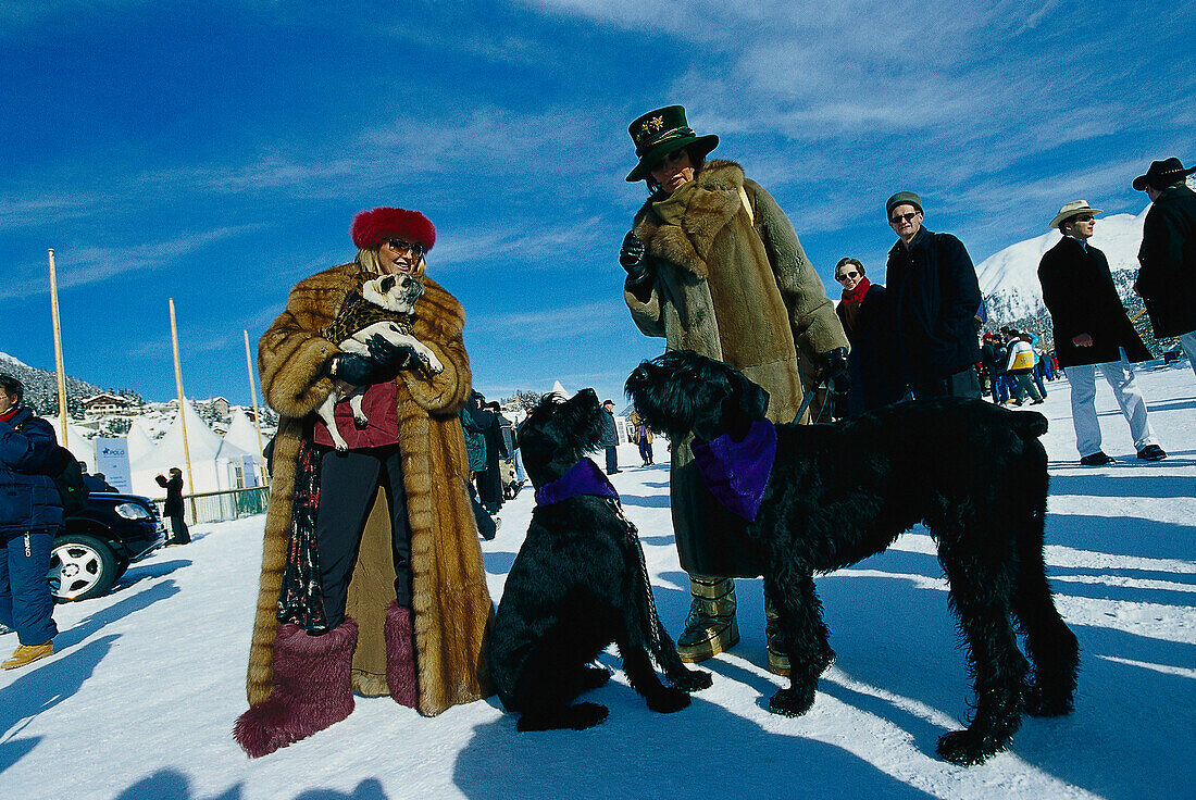 Women in fur coats and dogs, St. Moritz, Grisons, Switzerland, Europe