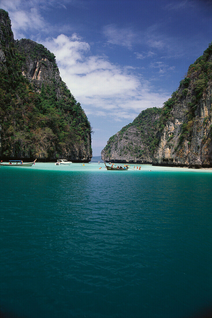 People bathing in a lagoon in front of high rocks, Ko Phi Phi, Thailand