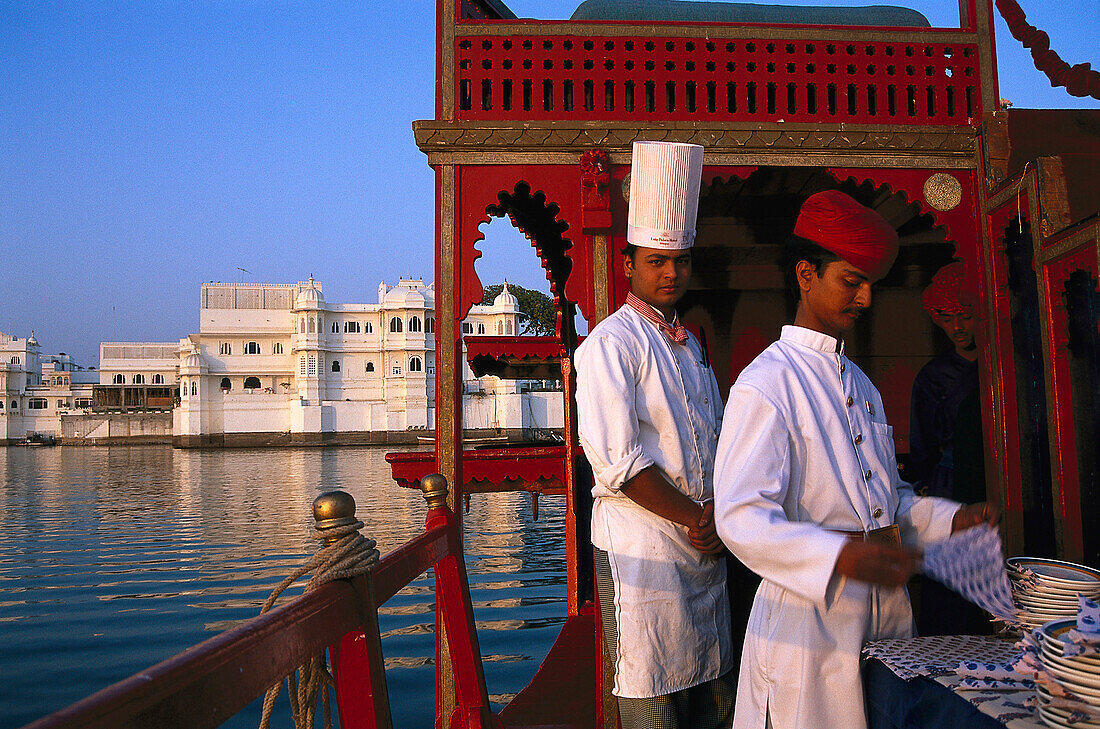 Cook and waiter on restaurant boat of Lake Palace Hotel, Lake Pichola, Udaipur, Rajasthan, India, Asia