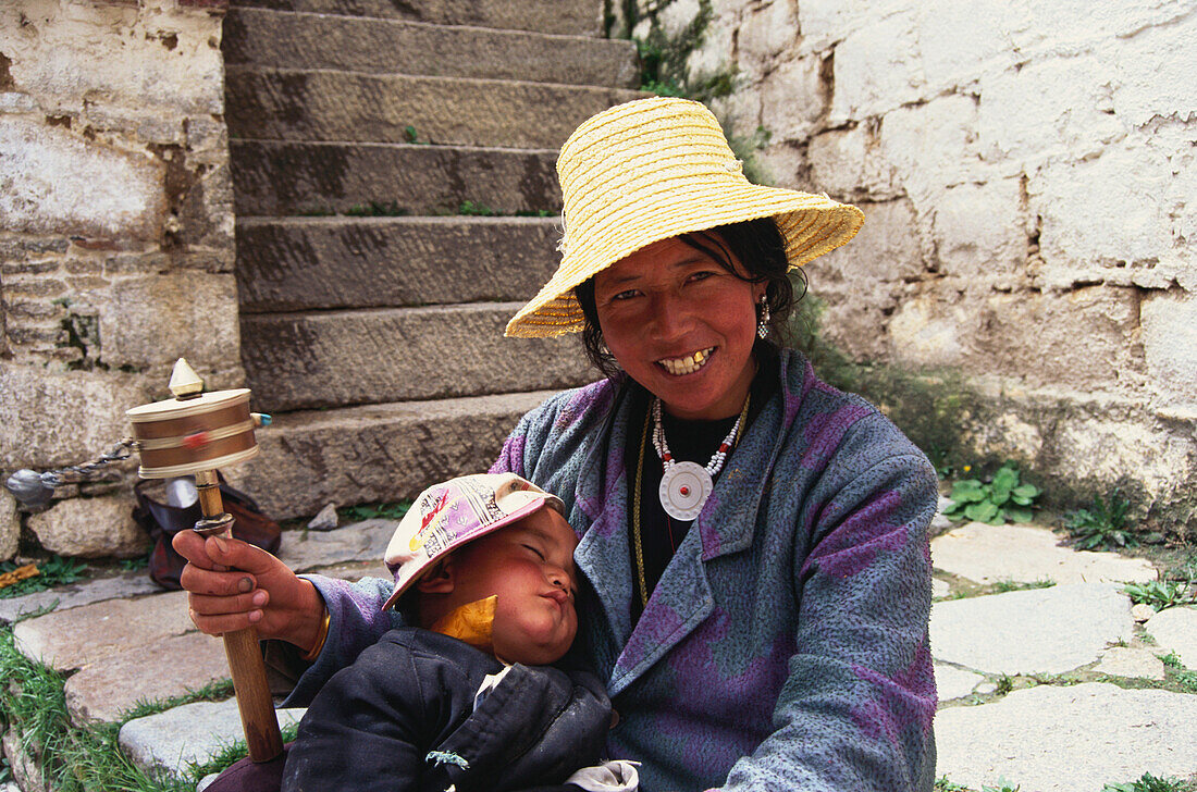 Tibetan woman with prayer wheel, Lhasa, Tibet, Asia