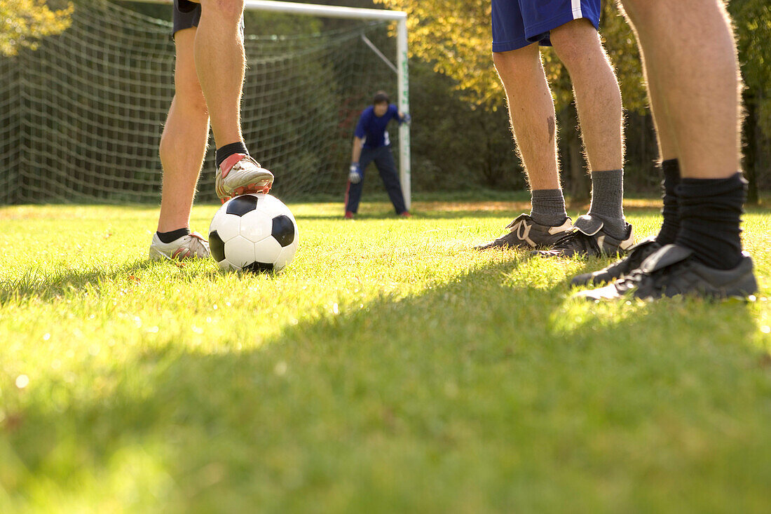 Young men preparing soccer ball for free kick