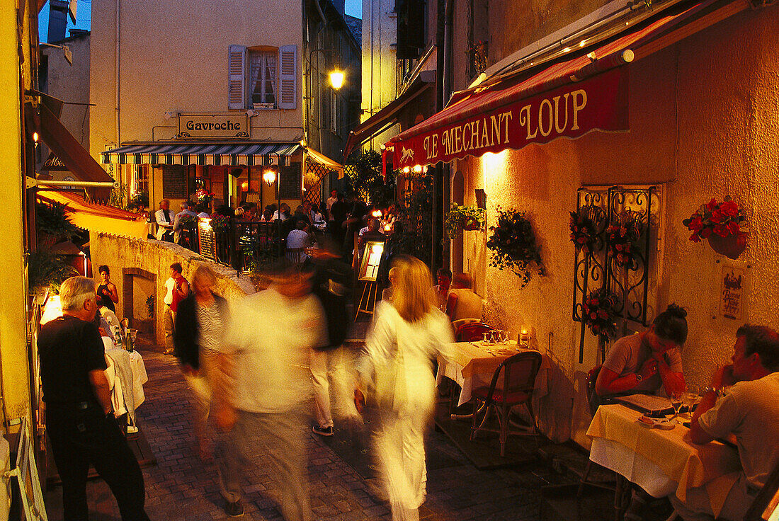 Restaurants in the evening light, Rue St. Antoine, old town of Le Suquet in Cannes, Cote d' Azur, France