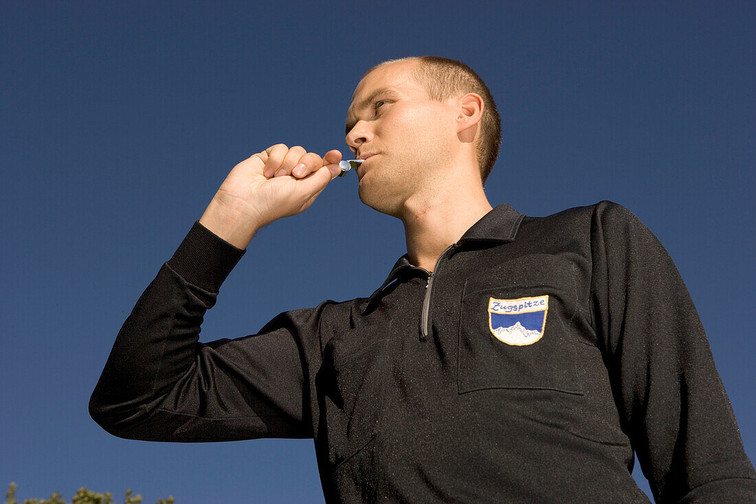 Referee blowing the whistle