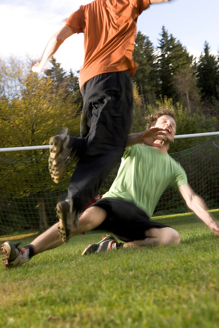 Young men playing soccer, fight scene