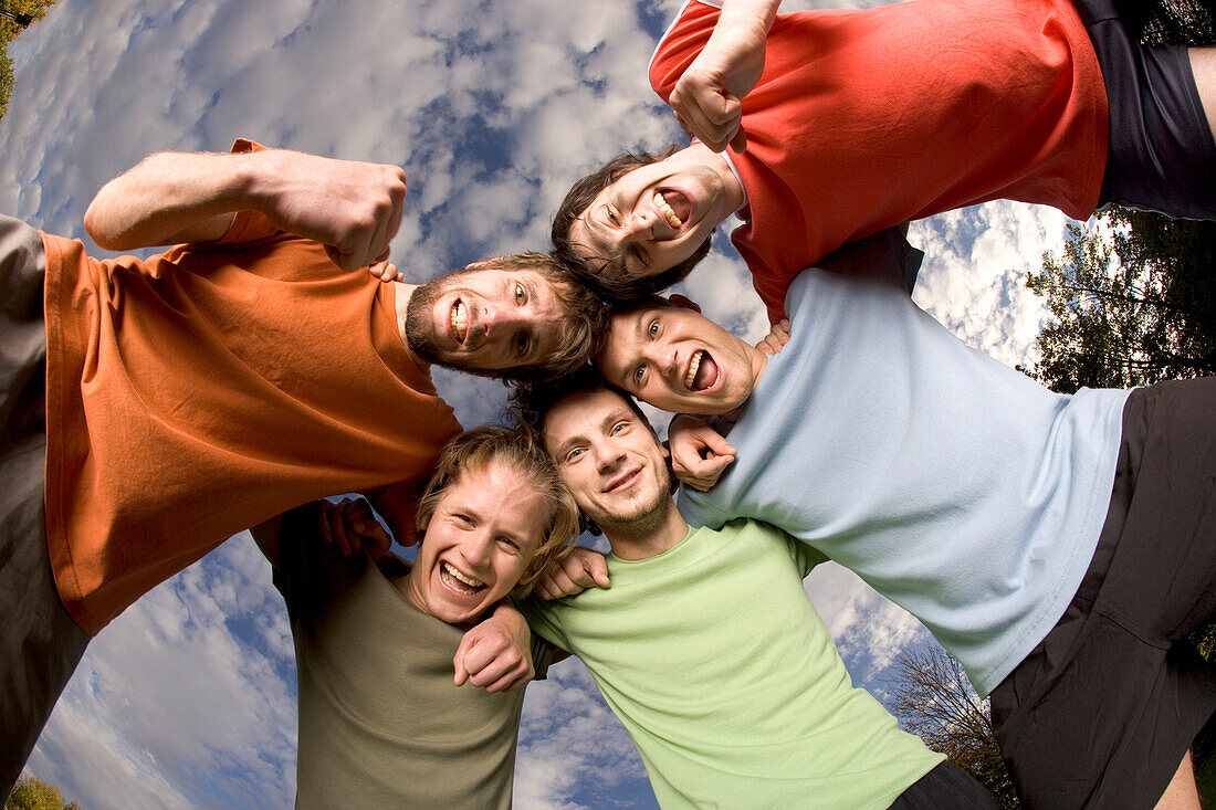 Young soccer players building a circle