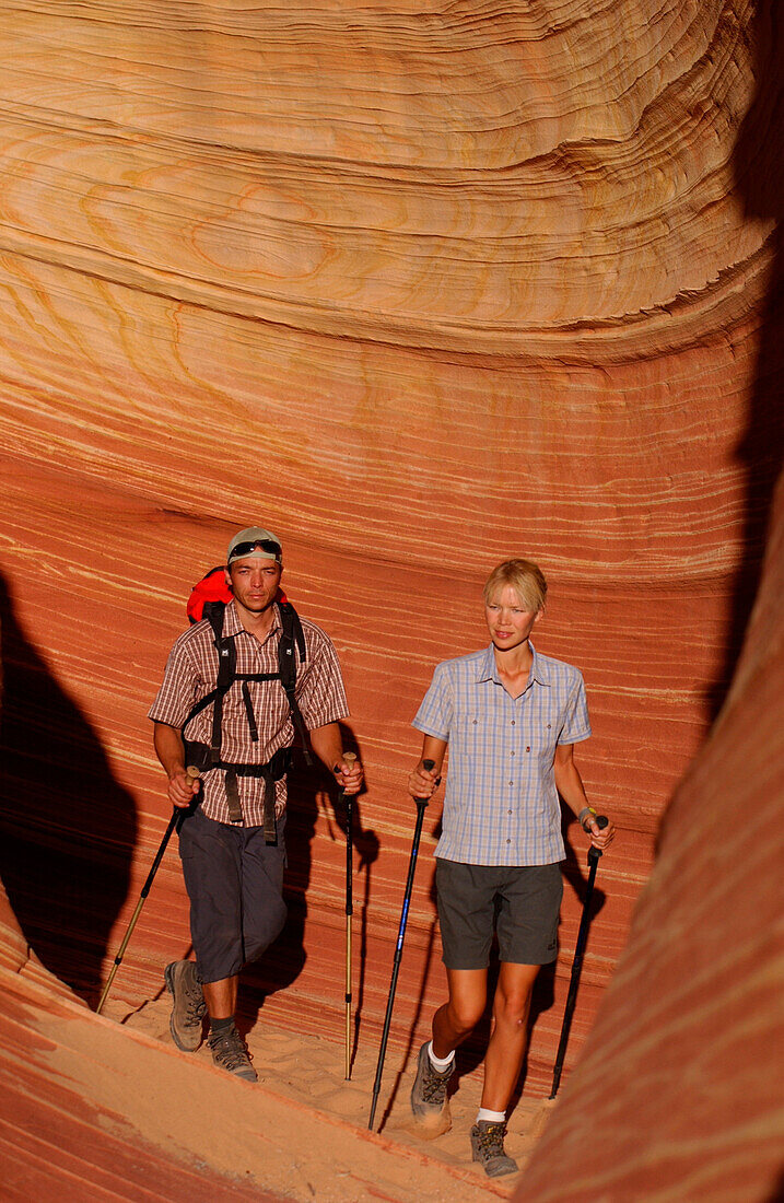 A couple trekking, hiking through landscape in Arizona