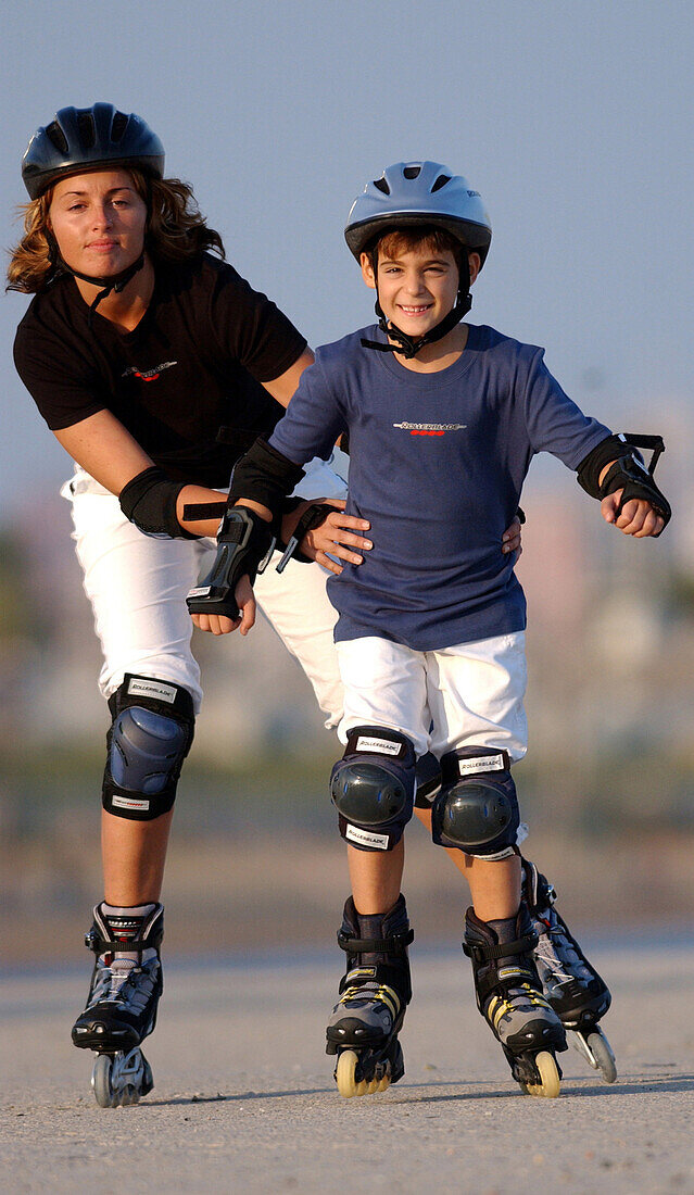 Mother and son inlining skating in Barcelona, Spain