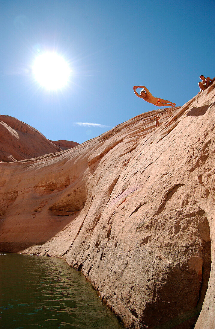 Man diving from a rock, cliff diving, Lake Powell, Arizona, USA