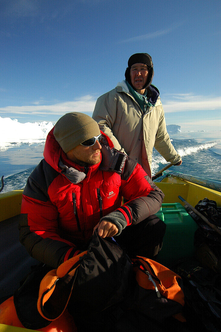 Two people in a fishing boat, Ilulissat, Greenland
