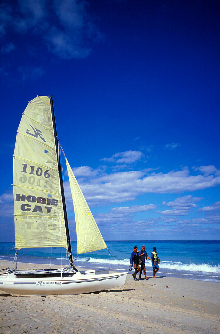 People and sailing boat on the beach, Playas del Este, Cuba, Caribbean, America