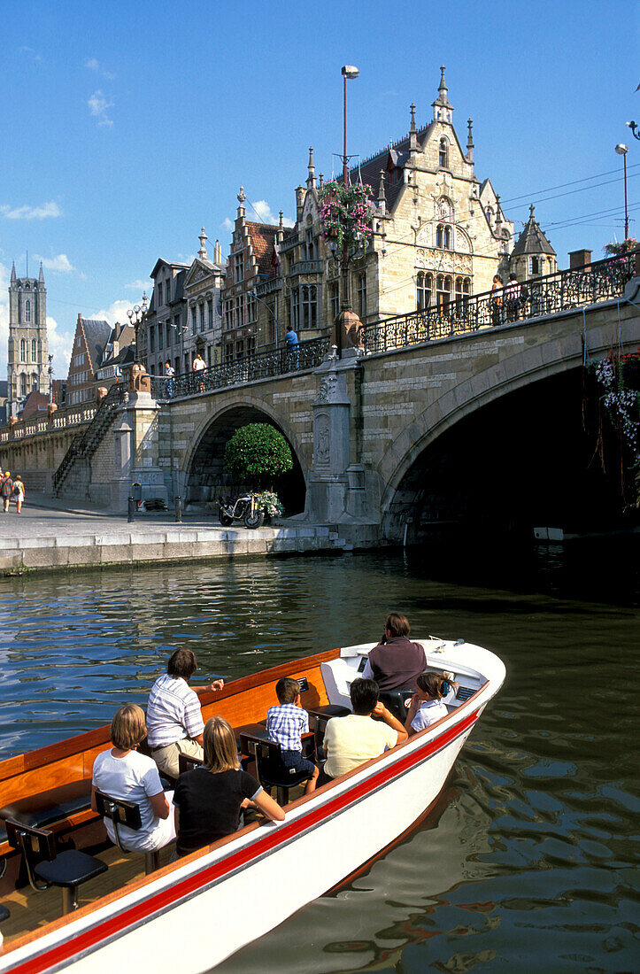 People in a boat and Graslei with St. Michiels bridge, Gent, Flanders, Belgium, Europe