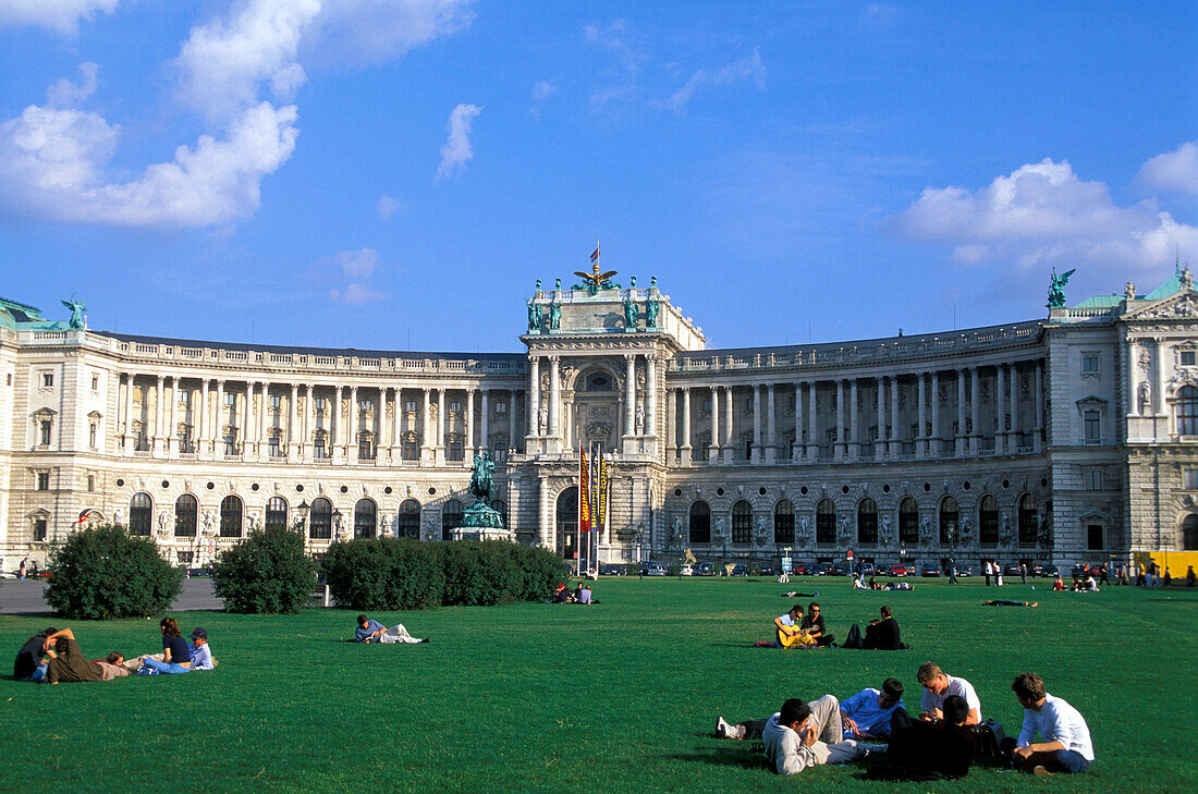 People on a meadow in front of Heldenplatz square and Neue Hofburg, Vienna, Austria, Europe