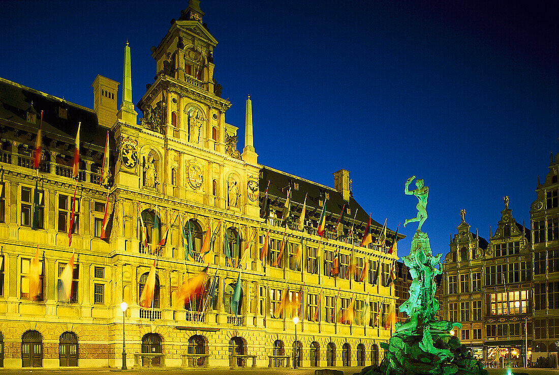 Illuminated town hall and Brabo fountain at night, Antwerp, Flanders, Belgium, Europe