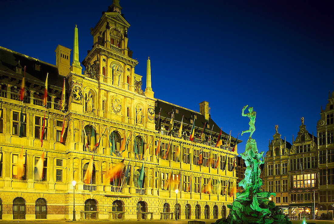 Illuminated town hall and Brabo fountain at night, Antwerp, Flanders, Belgium, Europe