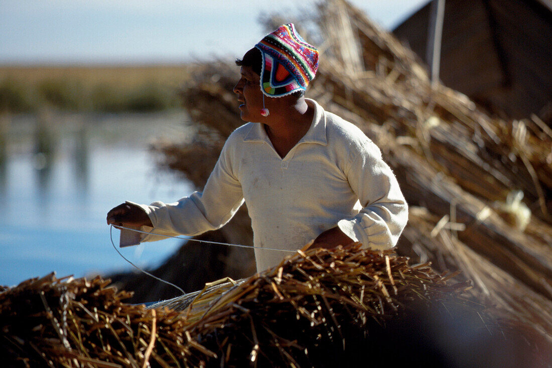 Indian building a boat, Puno, Lake Titicaca, Peru, South America, America