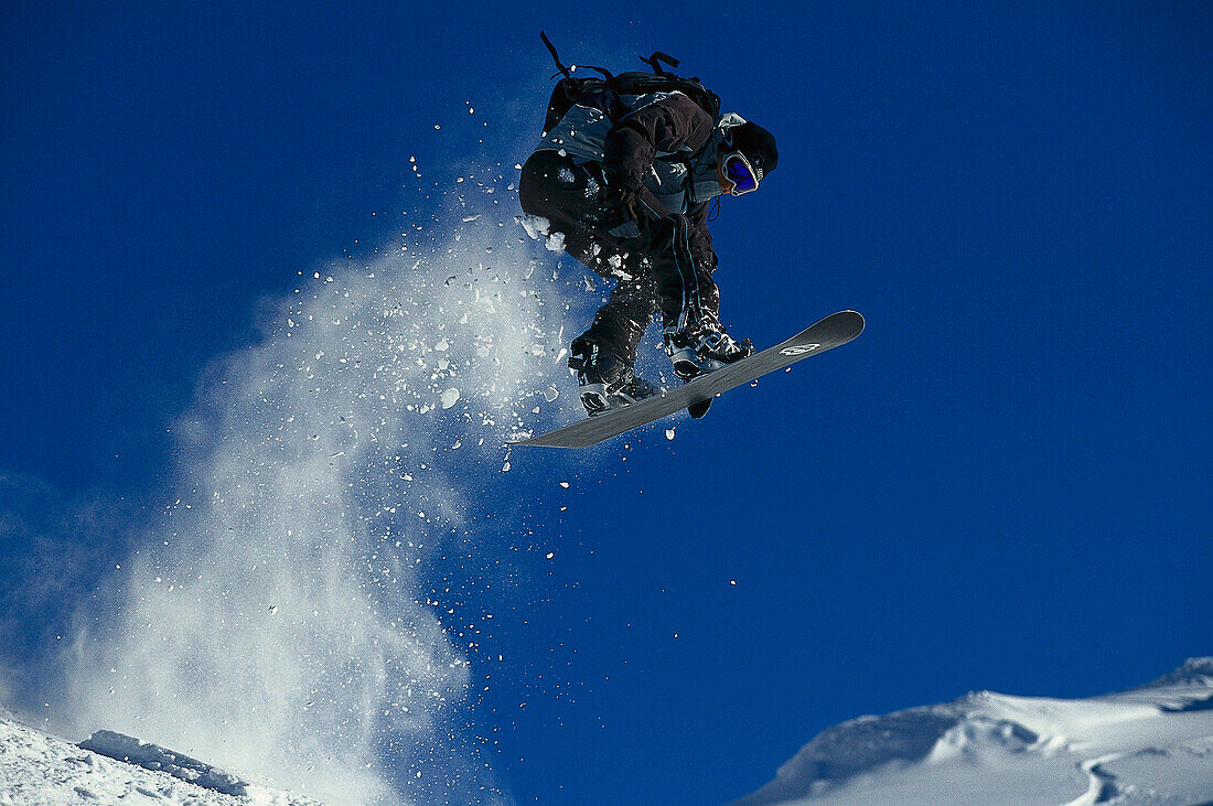 Snowboarder in action, Performing a jump, Valluga, Arlberg, Tyrol, Austria