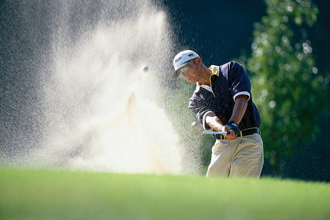 Golf player at shot from the bunker