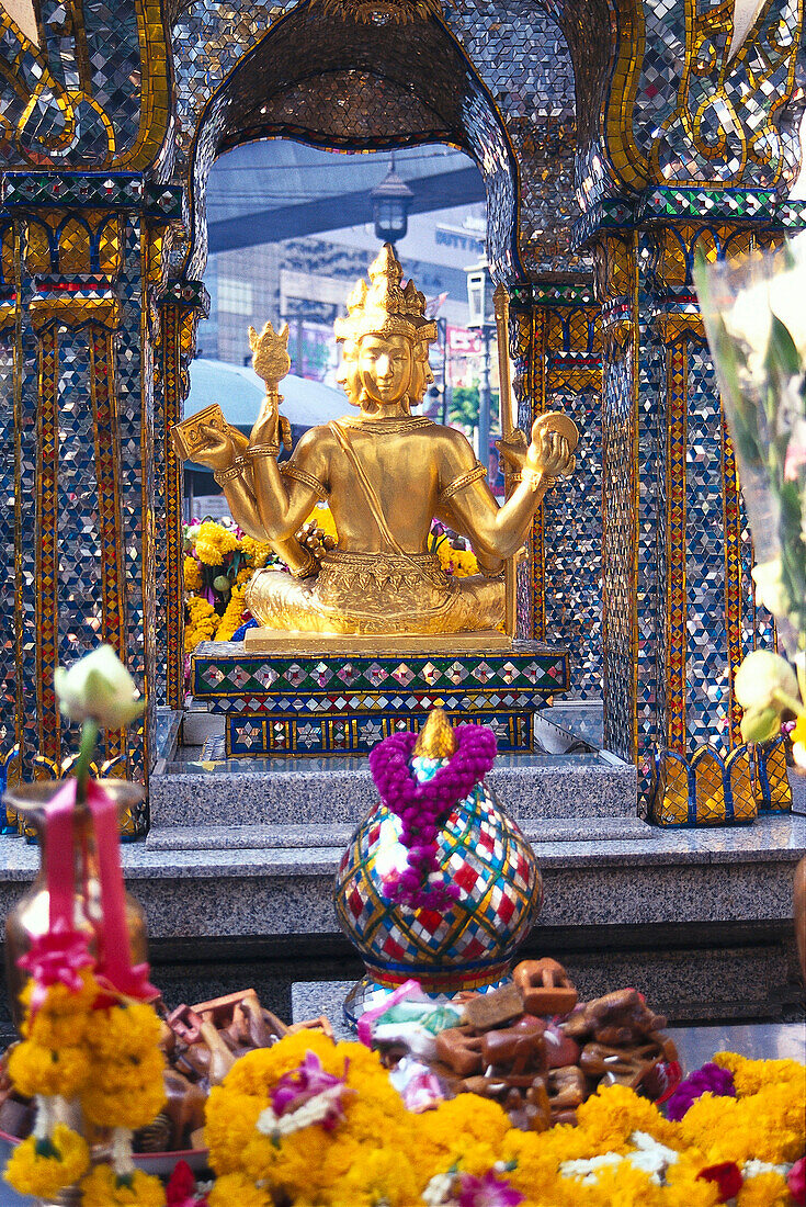 Golden figure and Erawan shrine, Bangkok, Thailand, Asia