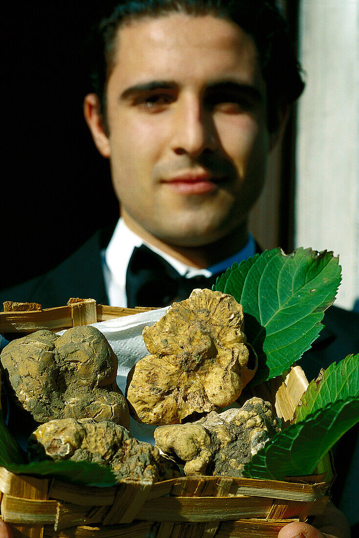Waiter with basket full of truffles, Restaurant Il Furlo, Acqualagna, Marche, Italy, Europe