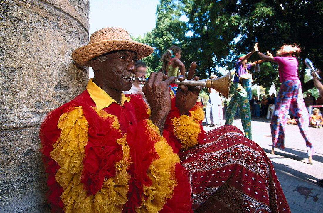 Street musician in the carneval costume playing wind instrument, Havanna, Cuba, Greater Antilles, Antilles, Carribean, Central America, North America, America