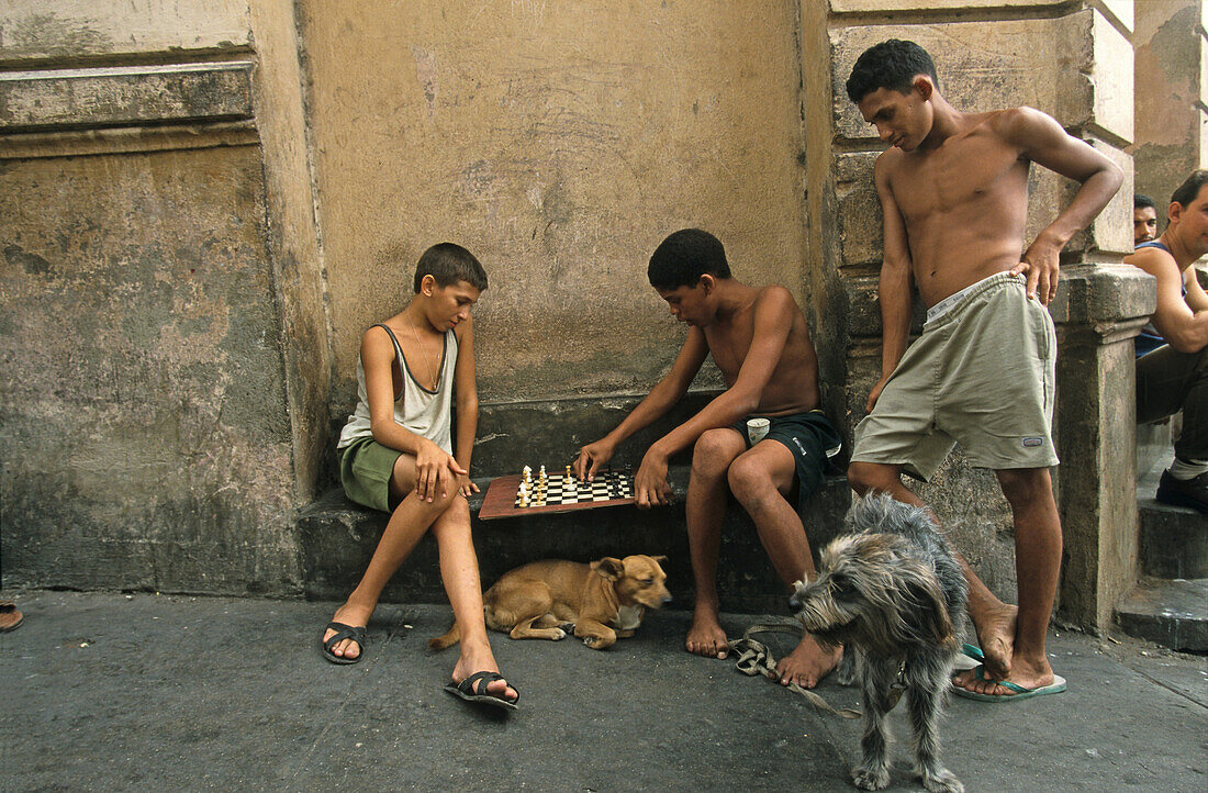 Cuba young boys playing chess on street corner, Cuba
