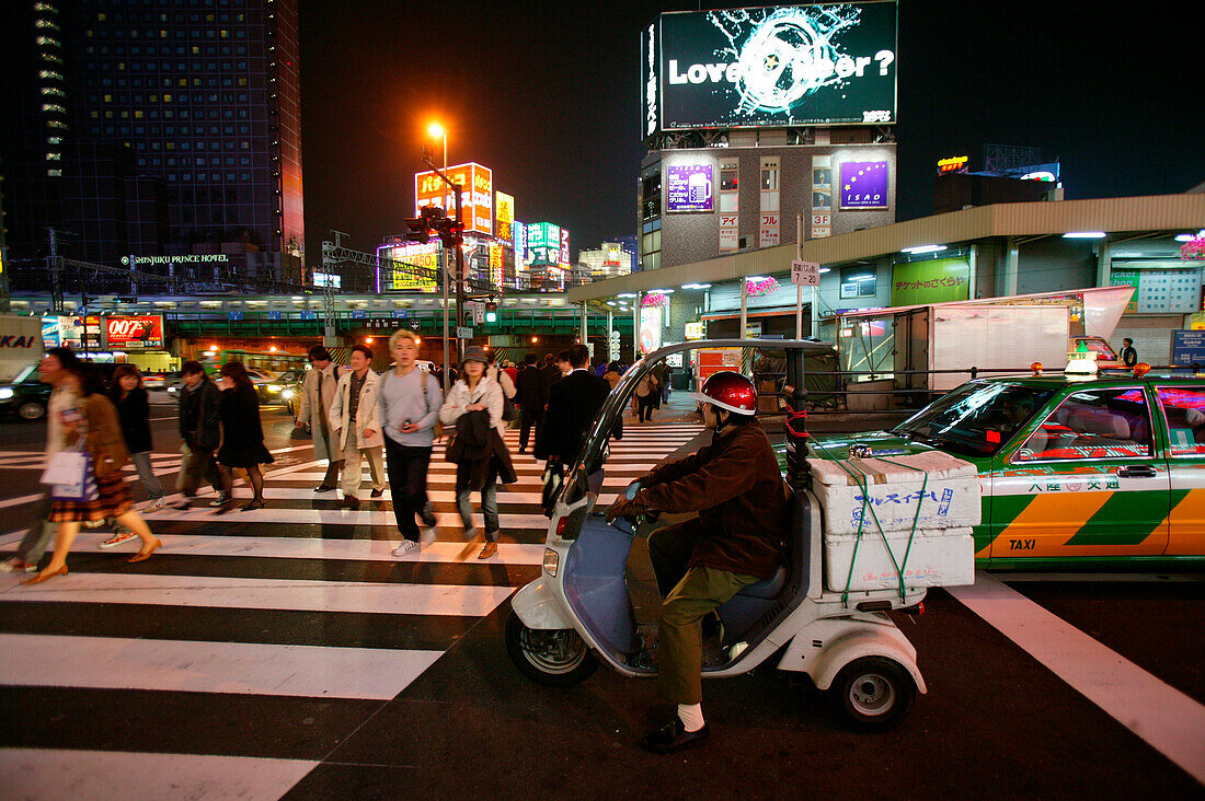 Street junction and pedestrian crossing at night, Shinjuku Tokyo, Japan