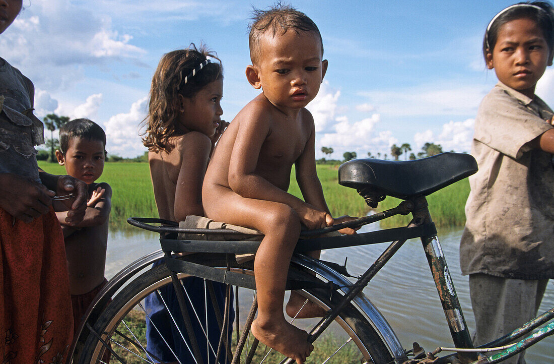 group of children and one bicycle, Cambodia, Asia