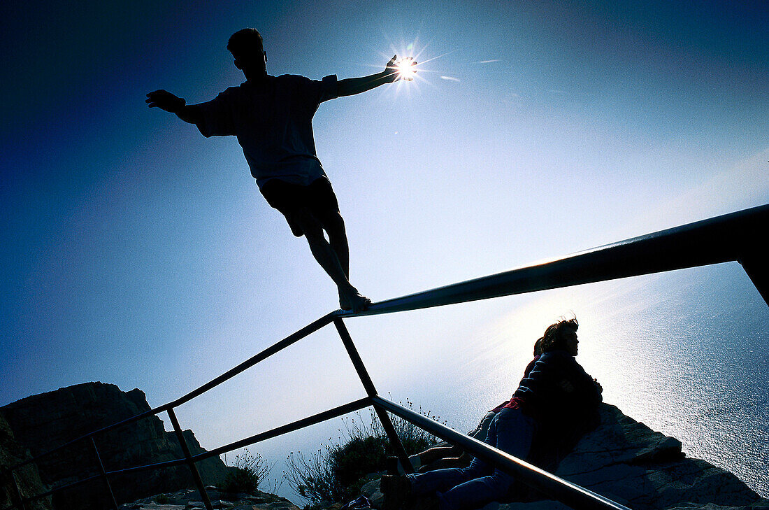 Teenager balancing on a balustrade, Calanque, France