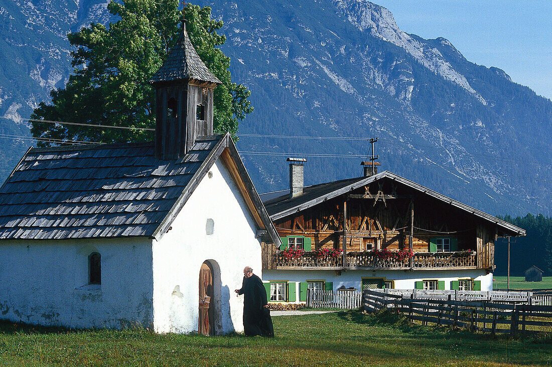 Priest locking his chapel, Tyrol, Austria