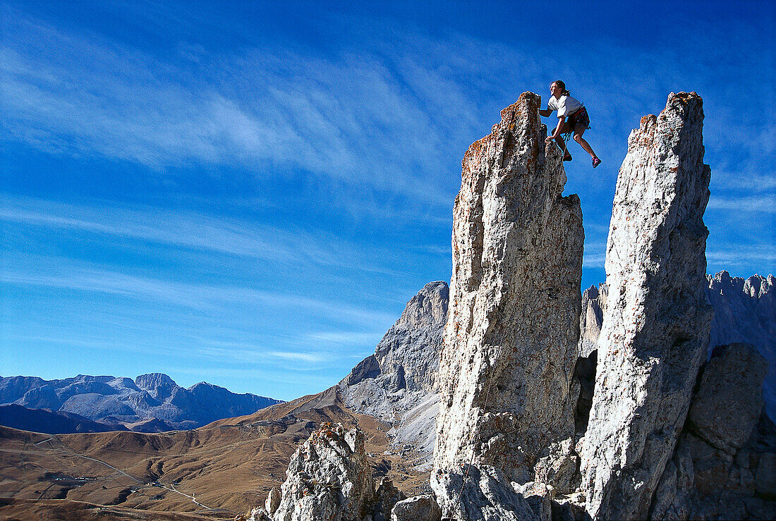 Free climber on rock pinnacle, Dolomites, Italy