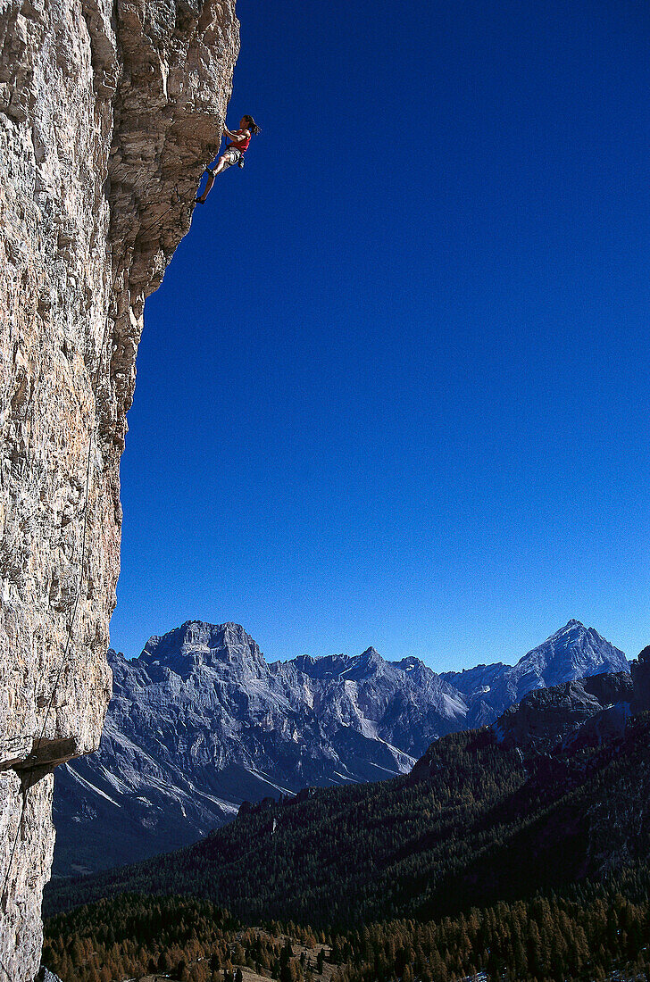 Man freeclimbing at rock face, Dolomites, Italy