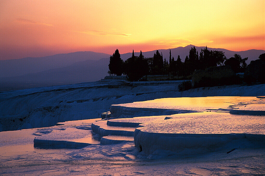 Sunset over the limestone sinter terraces, Pamukkale, Denizli, Turkey