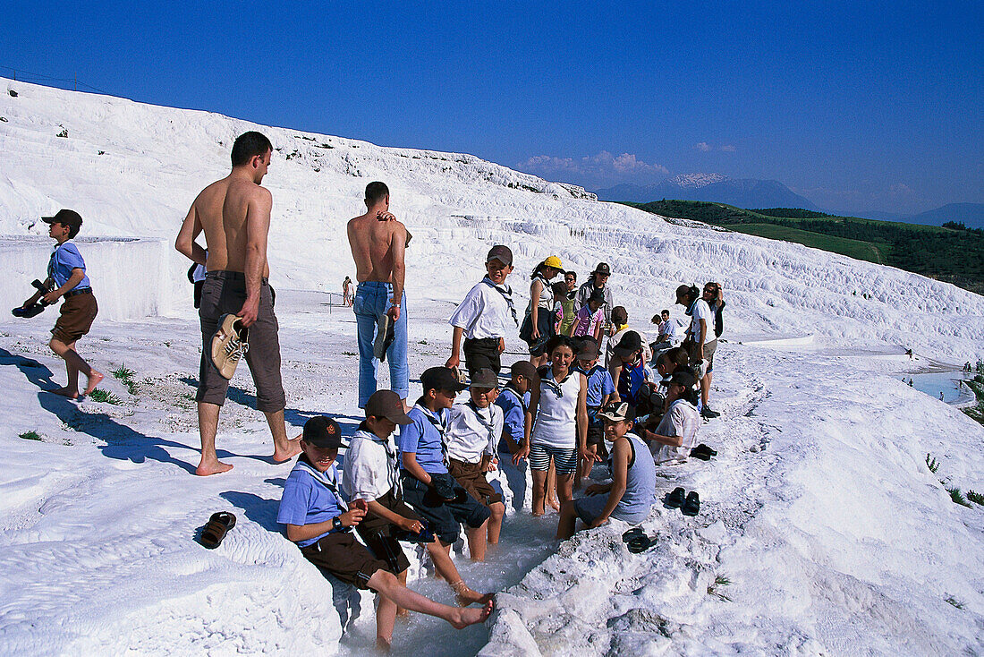 Boy scouts at the limestone sinter terraces, Pamukkale, Denizli, Turkey