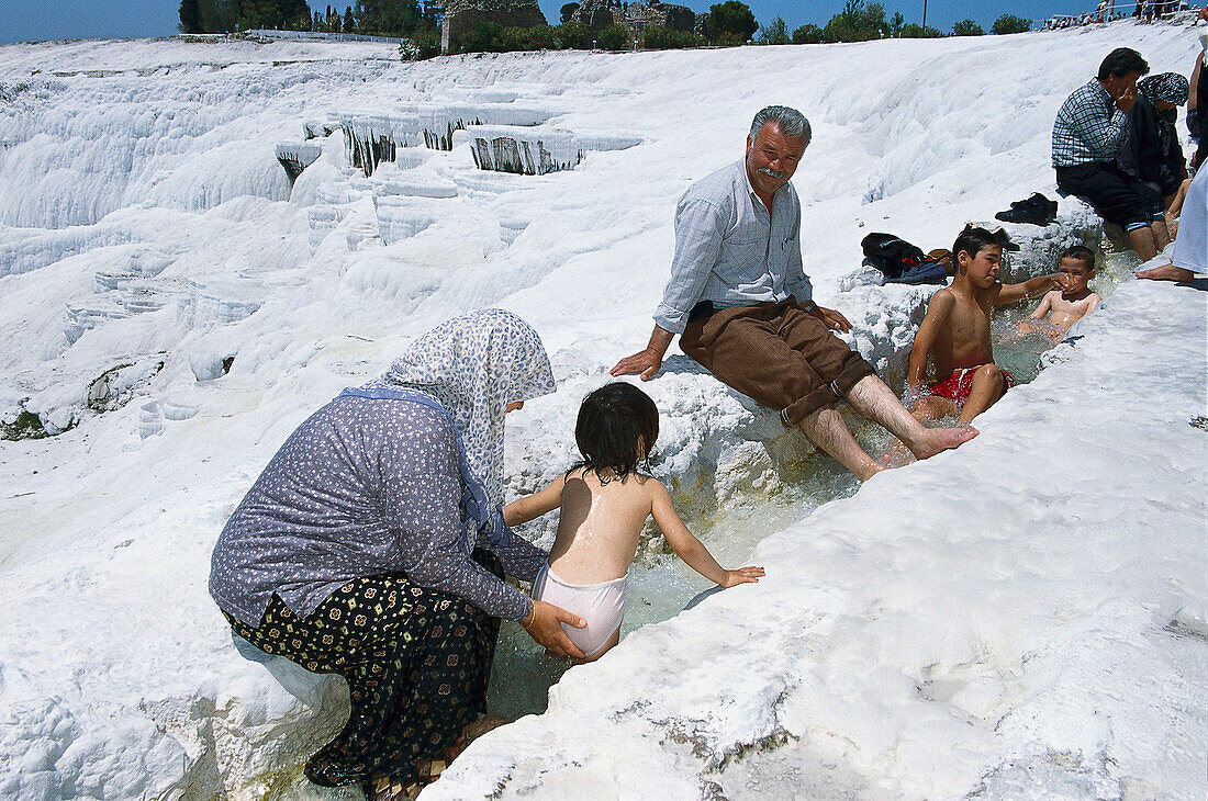 Turkish family at the limestone sinter terraces, Pamukkale, Denizli, Turkey