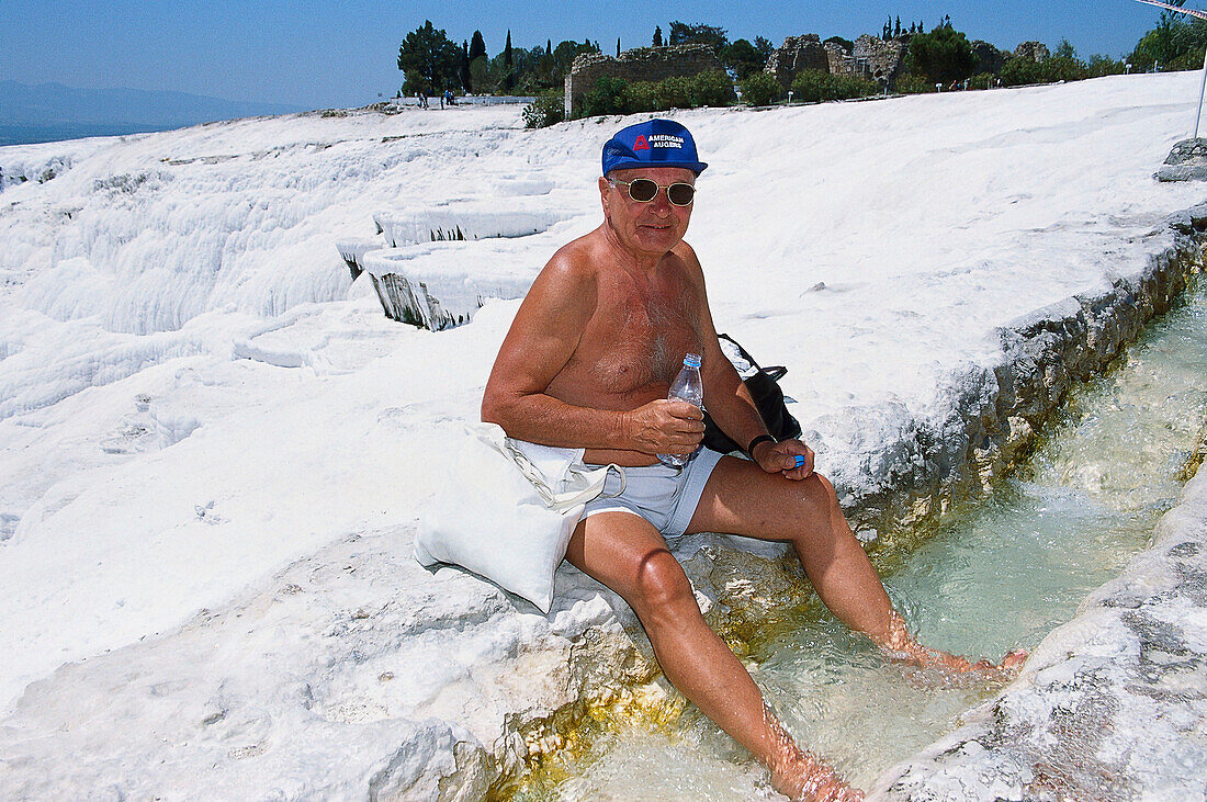 Tourist at the limestone sinter terraces, Pamukkale, Denizli, Turkey