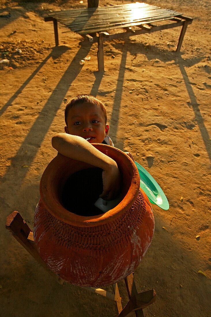 Child, drinking water in terracotta pot, Wasser aus dem Tonkrug, Tontopf, diese Wasserbehaelter stehen ueberall in Burma