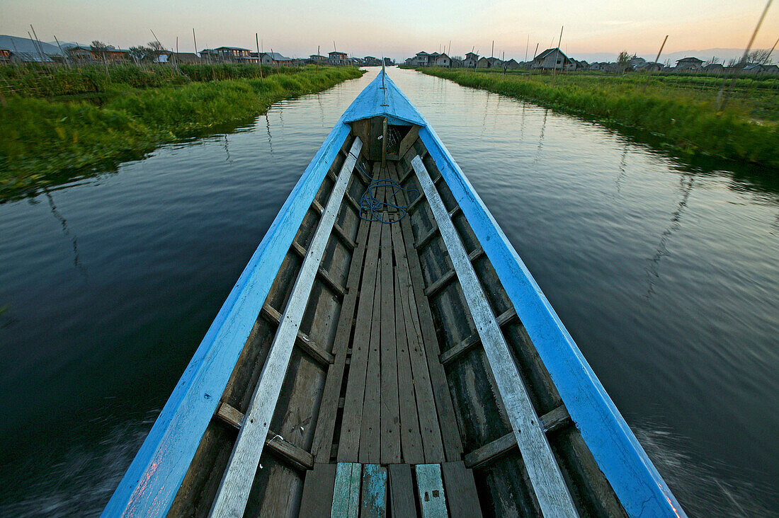longboat glides through floating gardens, Inle Lake, Myanmar