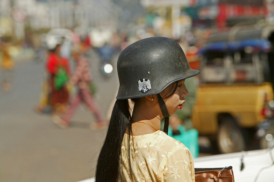 Burmese woman with German military helmet, Myanmar