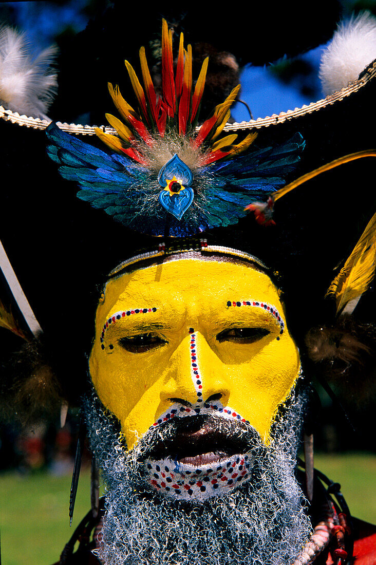 Local man with yellow painted face, Portrait, Huli Sing Sing festival, Mt Hagen, Eastern Highlands, Papua New Guinea, Melanesia