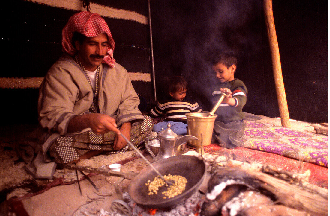 Bedouin family preparing food, Rum Village, Wadi Rum, Jordan, Middle East