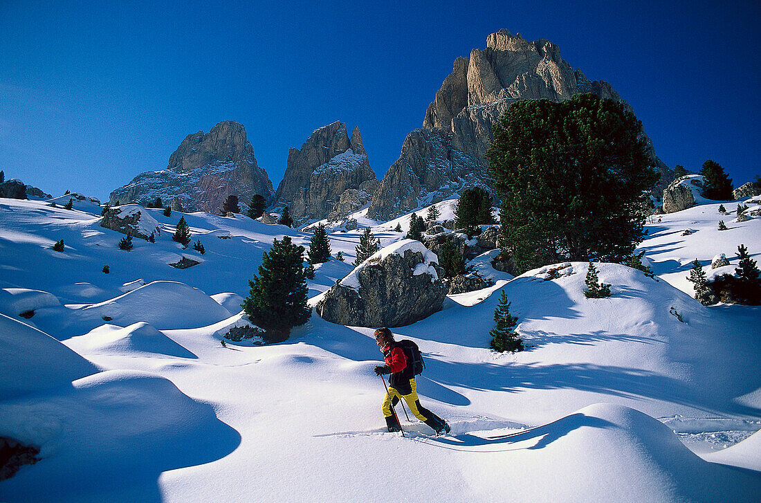 Young man snowshoeing, Sella-Ronda, Dolomites, Italy