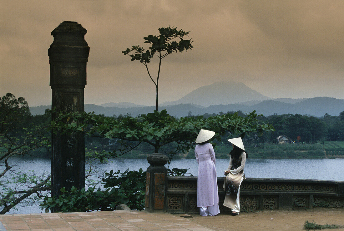 Two People in front of Perfume River, from Thiem Mu Pagoda, Hue, Vietnam