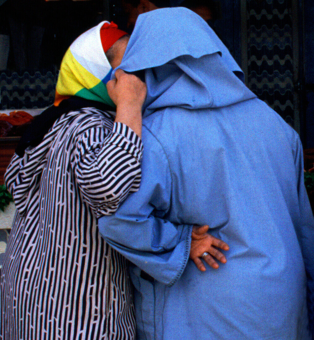 Two women talking to each other, Fes, Morocco, Africa