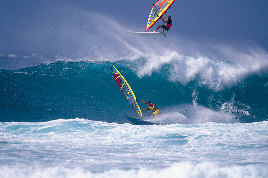 Two sailboarders in front of a wave, France, Europe